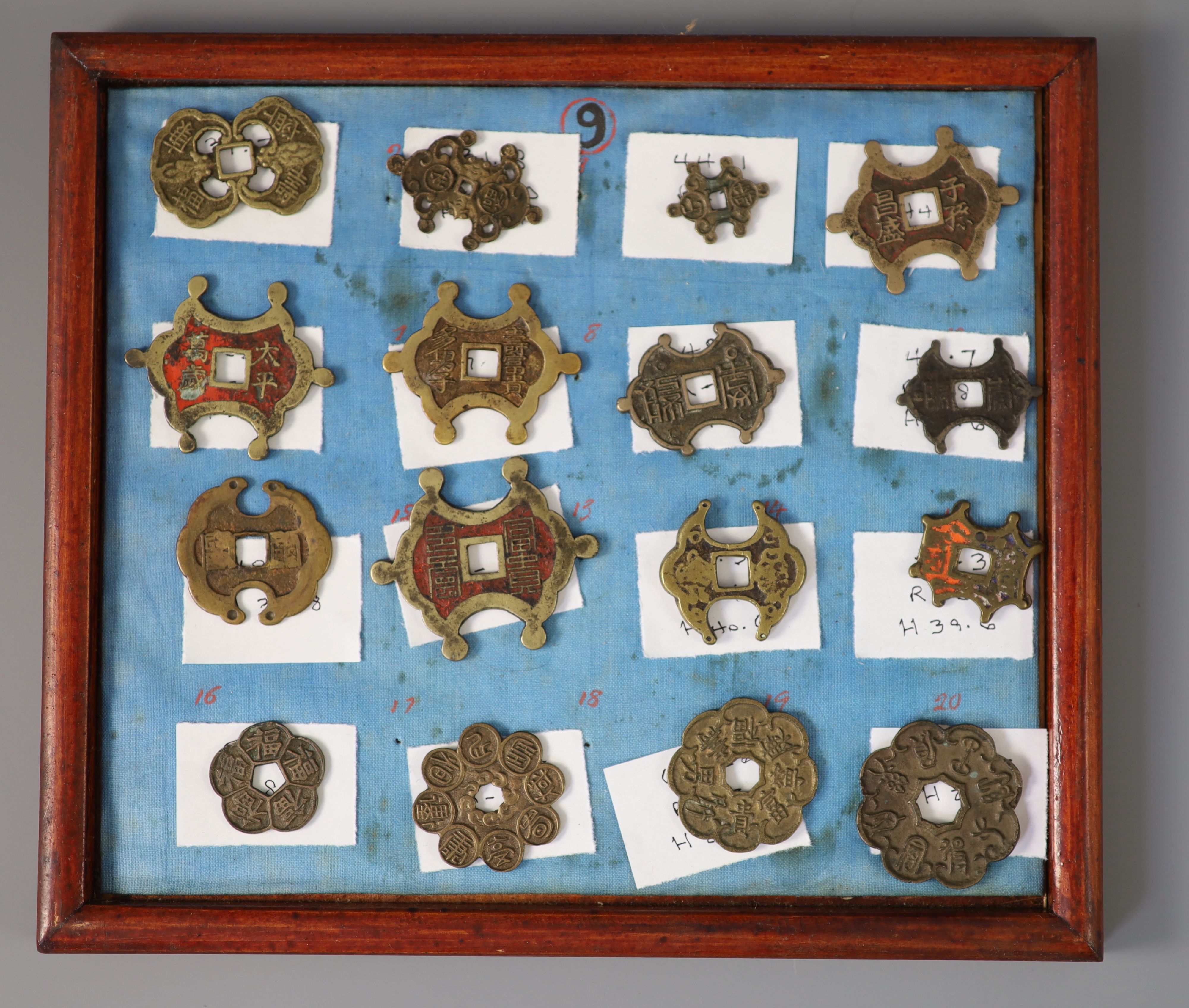 A group of 99 Korean bronze and metal amulets or charms, 19th/20th century